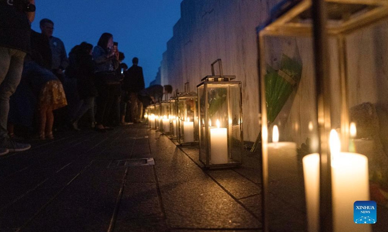 People visit the Wall of Names during a candlelight memorial to the passengers and crew of United Airlines Flight 93 in Shanksville, Pennsylvania, the United States, Sept. 10, 2021. Memorials were held at the Flight 93 National Memorial in Pennsylvania to mark the 20th anniversary of the Sept. 11 attacks.Photo:Xinhua