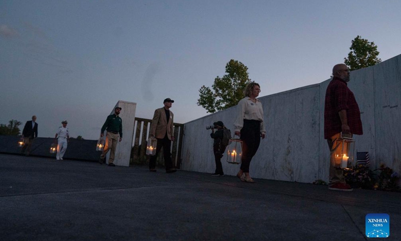 People visit the Wall of Names during a candlelight memorial to the passengers and crew of United Airlines Flight 93 in Shanksville, Pennsylvania, the United States, Sept. 10, 2021. Memorials were held at the Flight 93 National Memorial in Pennsylvania to mark the 20th anniversary of the Sept. 11 attacks.Photo:Xinhua