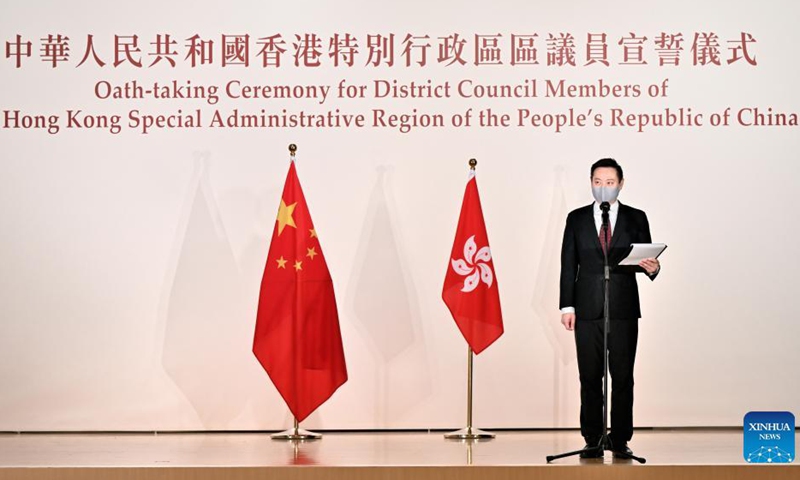 Secretary for Home Affairs of the Hong Kong Special Administrative Region (HKSAR) government Caspar Tsui (R), authorized by the HKSAR chief executive as the oath administrator, administers an oath-taking ceremony for the first group of district council members, at the North Point Community Hall in Hong Kong, south China, Sept. 10, 2021.Photo:Xinhua