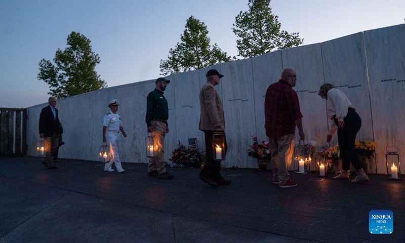 People visit the Wall of Names during a candlelight memorial to the passengers and crew of United Airlines Flight 93 in Shanksville, Pennsylvania, the United States, Sept. 10, 2021. Memorials were held at the Flight 93 National Memorial in Pennsylvania to mark the 20th anniversary of the Sept. 11 attacks.Photo:Xinhua