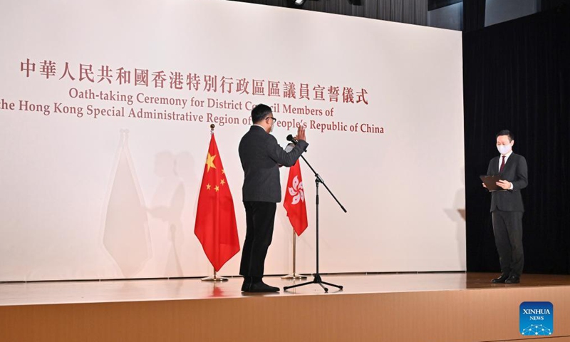 Secretary for Home Affairs of the Hong Kong Special Administrative Region (HKSAR) government Caspar Tsui (R), authorized by the HKSAR chief executive as the oath administrator, administers an oath-taking ceremony for the first group of district council members, at the North Point Community Hall in Hong Kong, south China, Sept. 10, 2021.Photo:Xinhua