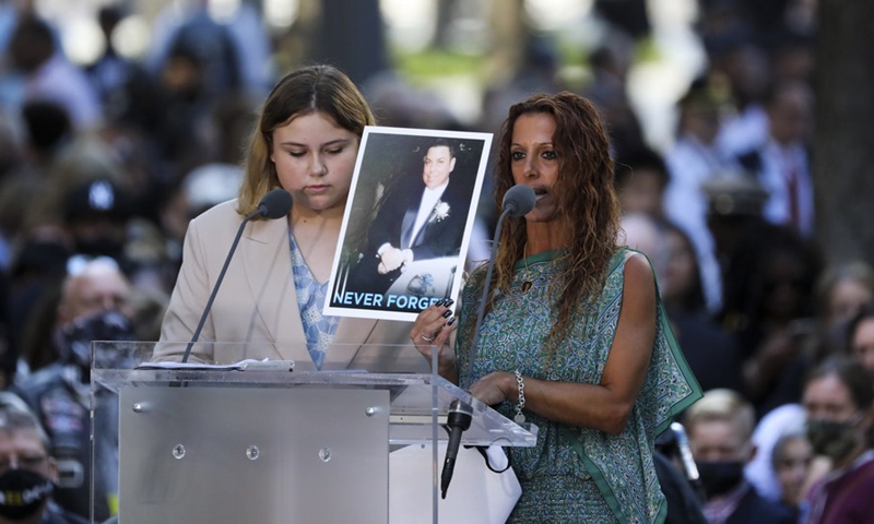 Relatives read victims' names during a commemoration ceremony of the 20th anniversary of the 9/11 attacks in New York, the United States, on Sept. 11, 2021.(Photo: Xinhua)