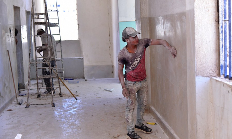 Workers rehabilitate a damaged school in the Daraya suburb, west of the capital Damascus, Syria, on Sept. 13, 2021. (Photo: Xinhua)