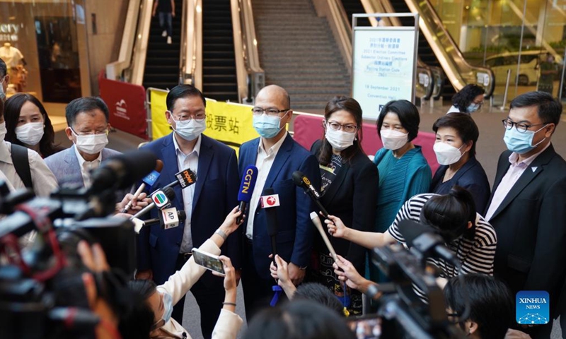 People receive interviews after casting their ballots at a polling station at Hong Kong Convention and Exhibition Center in Hong Kong, south China, Sept. 19, 2021. The 2021 Election Committee's subsector ordinary elections in China's Hong Kong Special Administrative Region (HKSAR) started on Sunday morning, the first election after the improvements to Hong Kong's electoral system earlier this year. Photo: Xinhua