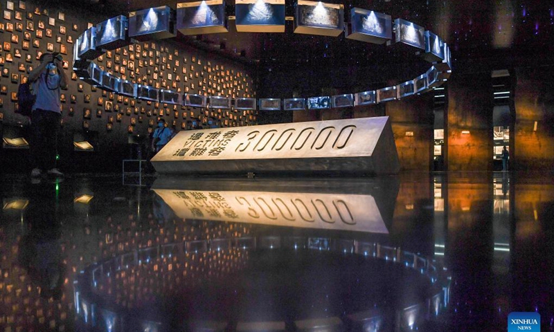 A reporter takes photos at the Memorial Hall of the Victims in Nanjing Massacre by Japanese Invaders in Nanjing, capital of east China's Jiangsu Province, Sept. 18, 2021. The memorial hall held a ceremony on Saturday to commemorate Nanjing Massacre survivors who have passed away this year. At present, the number of registered survivors of the massacre has decreased to 64. Photo: Xinhua