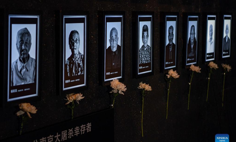 Photo taken on Sept. 18, 2021 shows pictures of Nanjing Massacre survivors at the Memorial Hall of the Victims in Nanjing Massacre by Japanese Invaders in Nanjing, capital of east China's Jiangsu Province. The memorial hall held a ceremony on Saturday to commemorate Nanjing Massacre survivors who have passed away this year. At present, the number of registered survivors of the massacre has decreased to 64. Photo: Xinhua