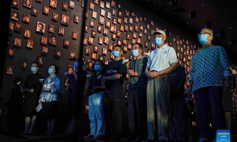 People attend a ceremony at the Memorial Hall of the Victims in Nanjing Massacre by Japanese Invaders in Nanjing, capital of east China's Jiangsu Province, Sept. 18, 2021. The memorial hall held a ceremony on Saturday to commemorate Nanjing Massacre survivors who have passed away this year. At present, the number of registered survivors of the massacre has decreased to 64.  Photo: Xinhua