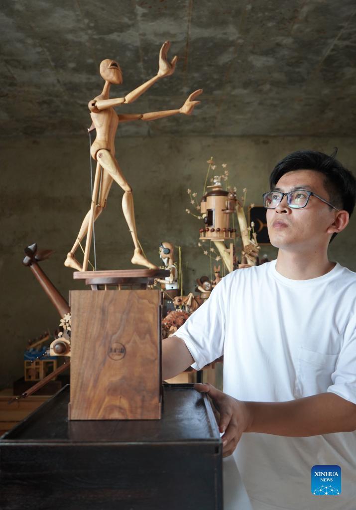 Li Zhanlong shows a wooden mechanical installation at his studio in Luquan District of Shijiazhuang, north China's Hebei Province, Sept. 14, 2021. Photo: Xinhua