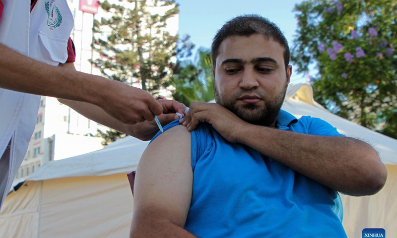 A Palestinian man receives a dose of the COVID-19 vaccine during a vaccination campaign in Gaza City, on Sept. 19, 2021. (Photo by Rizek Abdeljawad/Xinhua) 