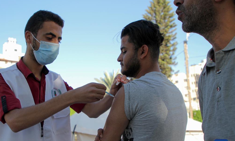 A Palestinian man receives a dose of the COVID-19 vaccine during a vaccination campaign in Gaza City, on Sept. 19, 2021. (Photo by Rizek Abdeljawad/Xinhua) 