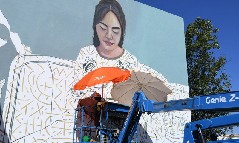 An artist paints a street art mural in Rabat, Morocco, Sept. 20, 2021.(Photo: Xinhua)