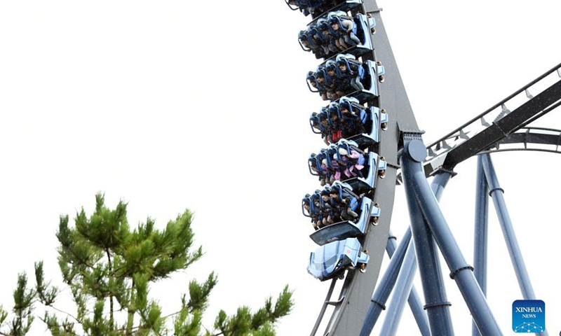 Tourists experience a roller coaster at the Universal Beijing Resort in Beijing, capital of China, Sept. 20, 2021. The Universal Beijing Resort, currently the largest in scale worldwide, opened to the public on Monday. The resort, covering 4 square km, includes the highly anticipated Universal Studios Beijing theme park, the Universal CityWalk, and two hotels.(Photo: Xinhua)