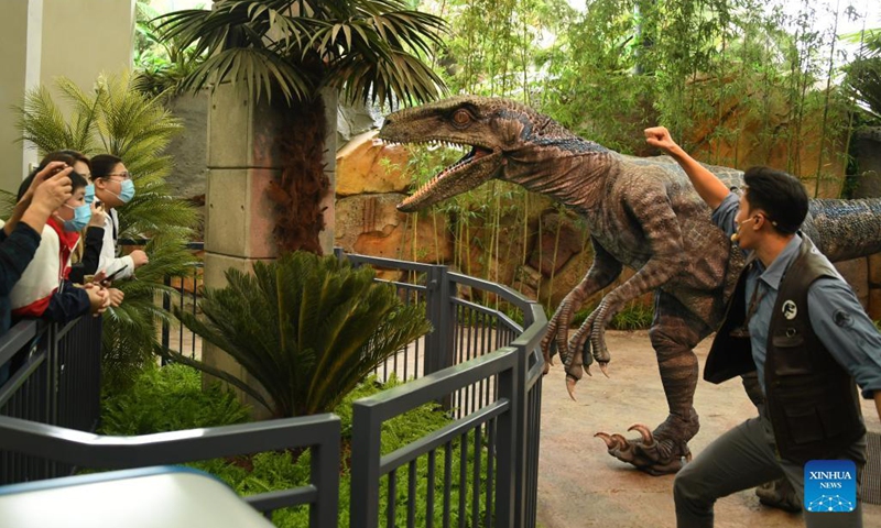 Tourists visit the theme land of Jurassic World Isla Nublar at the Universal Beijing Resort in Beijing, capital of China, Sept. 20, 2021. The Universal Beijing Resort, currently the largest in scale worldwide, opened to the public on Monday. The resort, covering 4 square km, includes the highly anticipated Universal Studios Beijing theme park, the Universal CityWalk, and two hotels.(Photo: Xinhua)