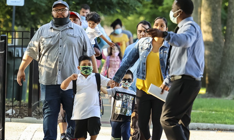 A family arrives for the first day of full attendance at Philip Rogers Elementary School in Chicago, on Aug. 30, 2021.(Photo: Xinhua)