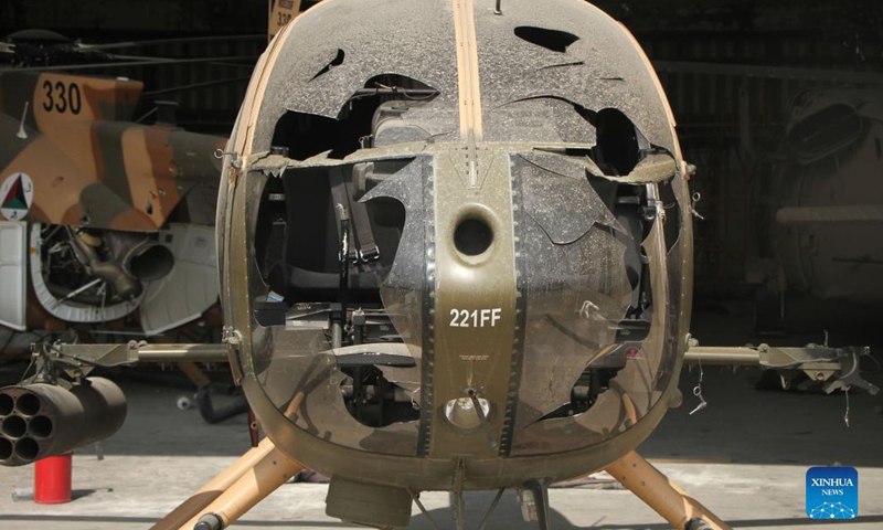 Photo taken on Sept. 20, 2021 shows a damaged helicopter of the Afghan Air Force at the Kabul airport in Kabul, capital of Afghanistan. The Kabul airport were damaged with its many facilities destroyed during the withdrawal of the last U.S.-led forces and U.S.-led evacuation flights in late August, according to airport director Abdul Hadi Hamadani on Monday.(Photo: Xinhua)