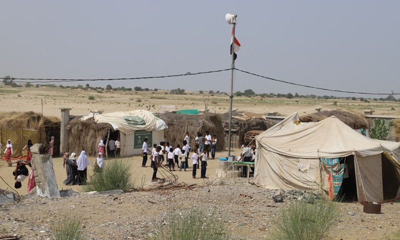 Students play on the yard of the Abi Talib primary school, which turns tents, straw huts and wooden cabins into makeshift classrooms, in Hajjah Province, Yemen, on Sept. 20, 2021.(Photo: Xinhua)
