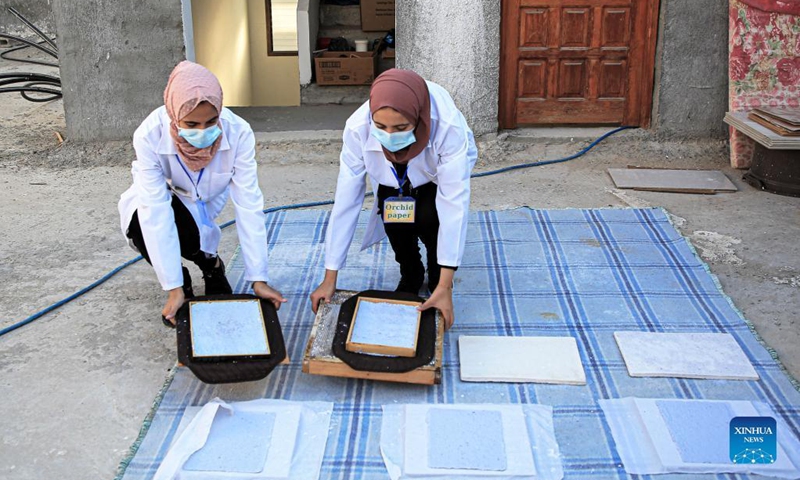 Volunteers process paper waste in al-Nuseirat refugee camp in the central Gaza Strip, on Sept. 16, 2021.(Photo: Xinhua)