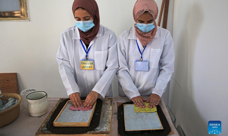 Volunteers process paper waste in al-Nuseirat refugee camp in the central Gaza Strip, on Sept. 16, 2021.(Photo: Xinhua)