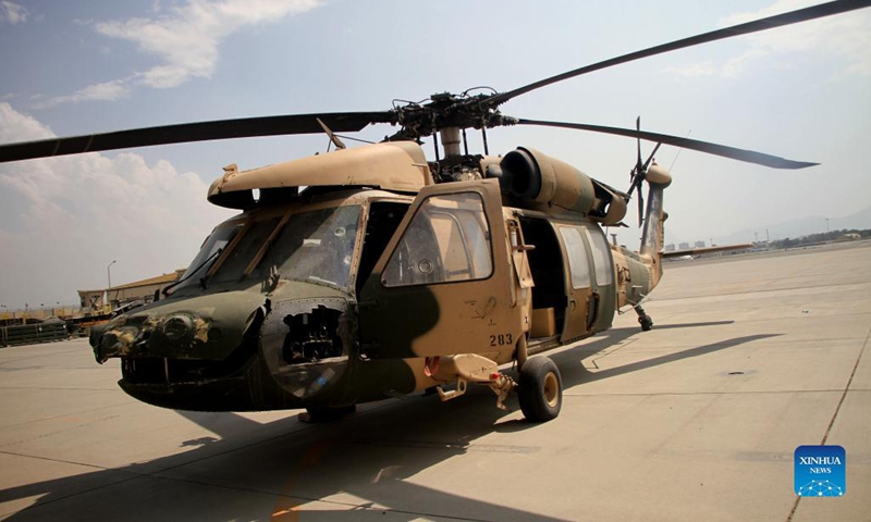 Photo taken on Sept. 20, 2021 shows a damaged helicopter of the Afghan Air Force at the Kabul airport in Kabul, capital of Afghanistan. The Kabul airport were damaged with its many facilities destroyed during the withdrawal of the last U.S.-led forces and U.S.-led evacuation flights in late August, according to airport director Abdul Hadi Hamadani on Monday.(Photo: Xinhua)