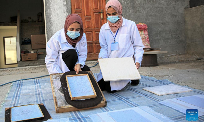 Volunteers process paper waste in al-Nuseirat refugee camp in the central Gaza Strip, on Sept. 16, 2021.(Photo: Xinhua)