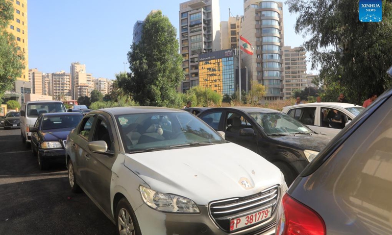 A long line of cars wait for fuel on a main road near a gas station in Beirut, Lebanon, on Sept. 21, 2021. Lebanon's Energy Ministry has raised gasoline prices for the second time in less than a week, effectively ending its fuel subsidy.(Photo: Xinhua)