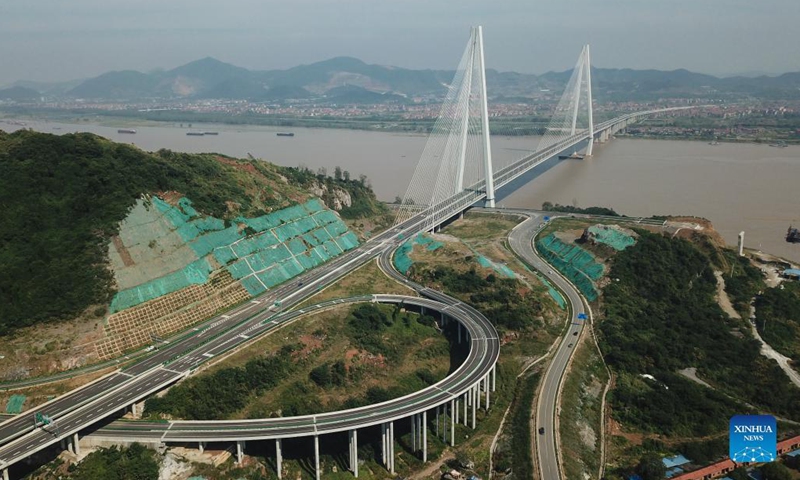 Aerial photo taken on Sept. 25, 2021 shows the Wuxue Yangtze River road bridge in central China's Hubei Province. Two new bridges over the Yangtze River opened to traffic Saturday in central China's Hubei Province. With a total length of 31 km and an 808-meter-long main span, the Wuxue Yangtze River road bridge links Wuxue City with Yangxin County of Huangshi City. The bridge has six lanes with a designed speed of 100 kph. (Photo: Xinhua)