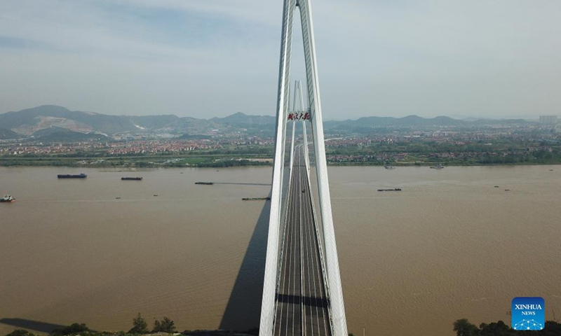 Aerial photo taken on Sept. 25, 2021 shows the Wuxue Yangtze River road bridge in central China's Hubei Province. Two new bridges over the Yangtze River opened to traffic Saturday in central China's Hubei Province. With a total length of 31 km and an 808-meter-long main span, the Wuxue Yangtze River road bridge links Wuxue City with Yangxin County of Huangshi City. The bridge has six lanes with a designed speed of 100 kph.(Photo: Xinhua)