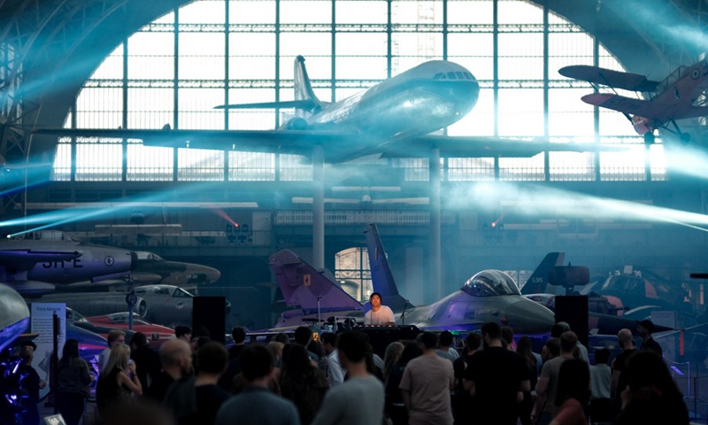 People attend the IIIMAGINE live electronic music show at the Aviation Hall of the Royal Museum of the Armed Forces and Military History in Brussels, Belgium, on Sept. 24, 2021.(Photo: Xinhua)