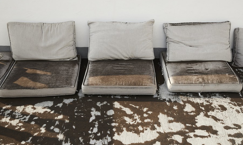 Photo taken on Sept. 24, 2021 shows outdoor sofa covered by dust in La Palma, Spain. (Photo: Xinhua)