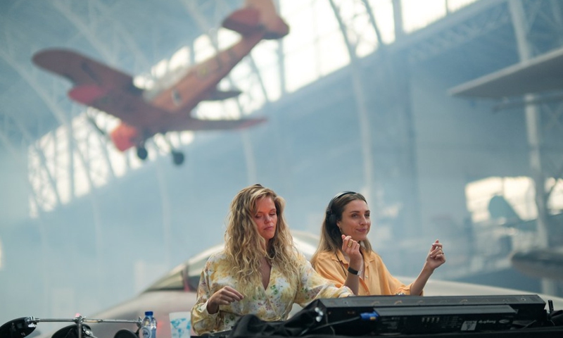 Disc jockeys are seen during the IIIMAGINE live electronic music show at the Aviation Hall of the Royal Museum of the Armed Forces and Military History in Brussels, Belgium, on Sept. 24, 2021.(Photo: Xinhua)