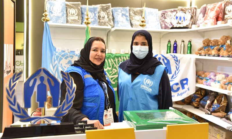 Photo taken on Oct. 1, 2021 shows two female exhibitor of the United Nations High Commissioner for Refugees (UNHCR) showing their cultural and creative product at the Riyadh International Book Fair, Saudi Arabia.(Photo: Xinhua)