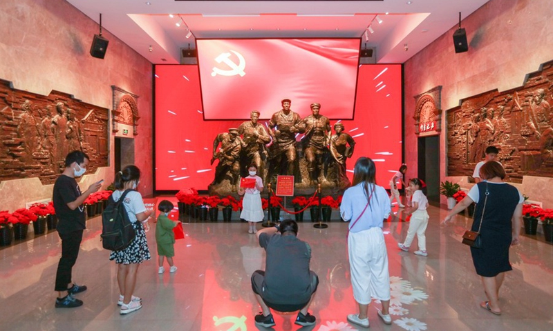 Tourists take photos at the memorial of the fourth National Congress of the Communist Party of China (CPC) in east China's Shanghai, Oct. 3, 2021.(Photo: Xinhua)