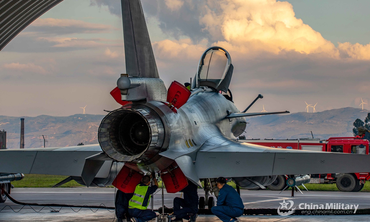 Maintenance men assigned to an aviation brigade of the air force under the PLA Southern Theater Command conduct pre-flight check on a fighter jet before a round-the-clock training exercise on Sept. 8, 2021. (eng.chinamil.com.cn/Photo by Wang Guoyun)


