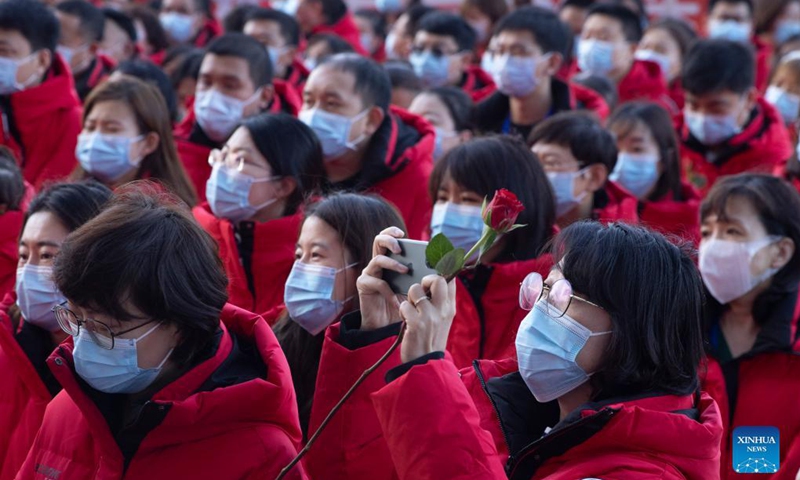 A medical worker from Jilin Province takes photos before returning in Harbin, northeast China's Heilongjiang Province, Oct. 4, 2021. A total of 266 medical workers from Hebei and Jilin provinces who came to aid Harbin in nucleic acid testing left the city on Monday after finishing their work. (Xinhua/Zhang Tao)

