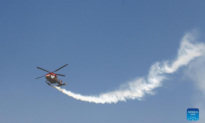 An Indian Air Force's Sarang helicopter performs during the 89th Indian Air Force Day celebrations at Hindon Air Force station in Ghaziabad, India, Oct. 8, 2021.Photo:Xinhua