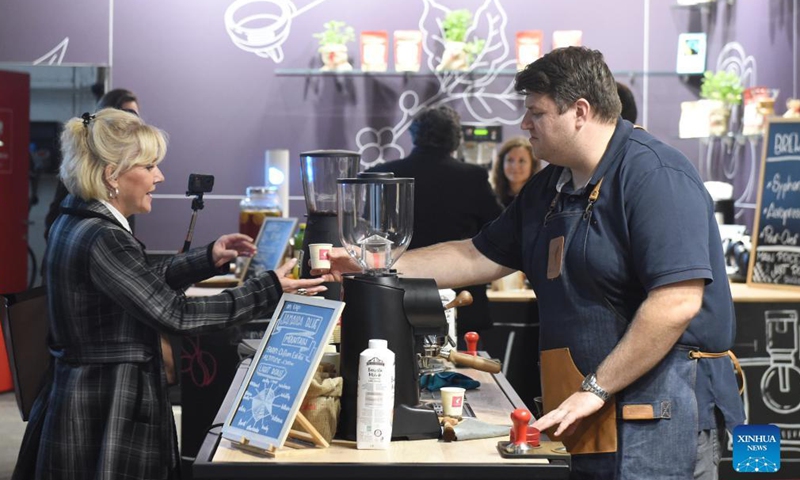 A barista passes a cup of coffee to a visitor during the 2021 Vienna Coffee Festival in Vienna, Austria, on Oct. 8, 2021. The 2021 Vienna Coffee Festival is held here in the Ottakringer Brewery from Oct. 8 to Oct. 10, attracting over 60 exhibitors from all over the world.Photo:Xinhua