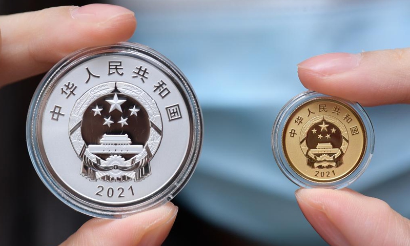 Photo taken on Oct. 9, 2021 shows the obverse of the commemorative coins to celebrate the 2020 UN Biodiversity Conference, in Beijing, capital of China. China's central bank is set to issue a set of commemorative coins on Oct. 11, 2021 to celebrate the 2020 UN Biodiversity Conference. The commemorative set contains one gold coin and one silver coin.Photo:Xinhua