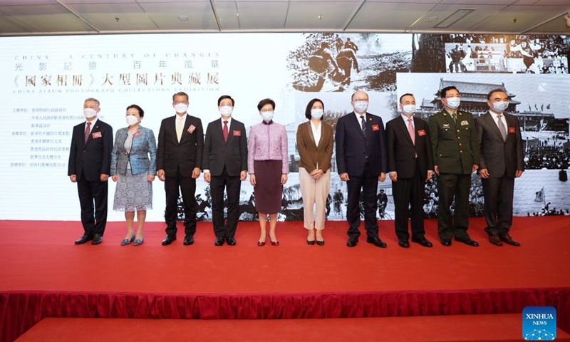 Guests pose for a group photo during the opening ceremony of a photo exhibition at Hong Kong Central Library in Hong Kong, south China, Oct. 8, 2021. A photo exhibition that opened Friday in Hong Kong showcased the unfading blood ties between Hong Kong and the motherland over the past 100 years, as well as the great achievements of China.Photo:Xinhua