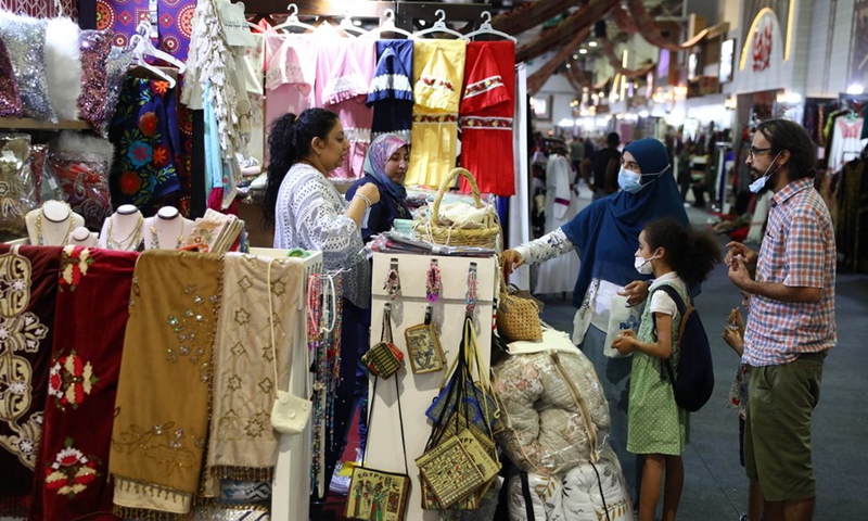 Visitors buy handicrafts at a booth during a heritage exhibition held in Cairo, Egypt, on Oct. 10, 2021.(Photo: Xinhua)