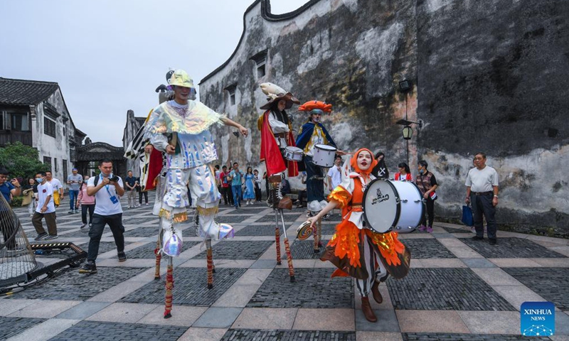 Actors perform during a carnival of the 8th Wuzhen Theater Festival in Wuzhen scenic spot of Tongxiang City, east China's Zhejiang Province, Oct. 15, 2021. The theater festival kicked off here on Friday. Photo:Xinhua