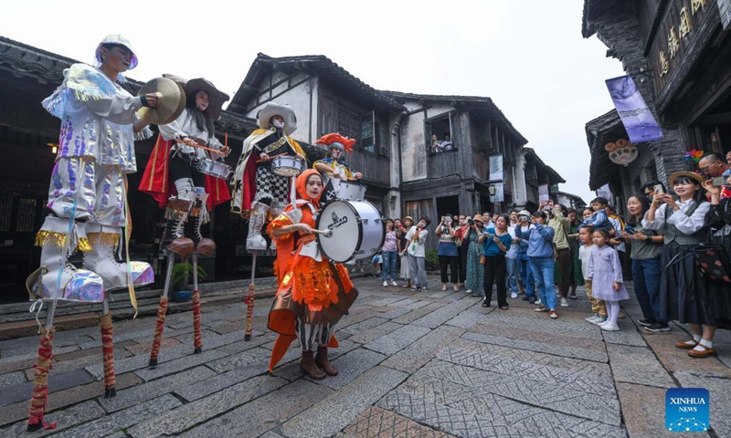 Actors perform during a carnival of the 8th Wuzhen Theater Festival in Wuzhen scenic spot of Tongxiang City, east China's Zhejiang Province, Oct. 15, 2021. The theater festival kicked off here on Friday. Photo:Xinhua