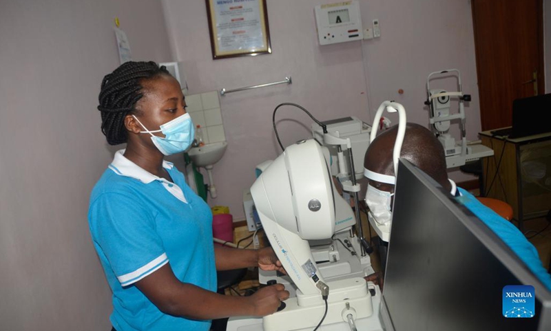 A man looks into tonometer for eyesight test during a free eye screening medical camp at Mengo Hospital, Kampala, Uganda, Oct. 15, 2021. To mark the World Sight Day that falls on Oct. 14 this year, over 300 people with diabetes received free eye screening treatment during a two-day medical camp event in Kampala.(Photo: Xinhua)