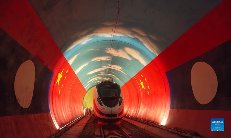 The Lane Xang EMU train passes by the China-Laos borderline inside a tunnel, Oct. 15, 2021. The streamlined China-standard bullet train, or electric multiple unit (EMU) train, for the China-Laos railway arrived at the newly built China-Laos Railway Vientiane Station on Saturday. (Photo: Xinhua)