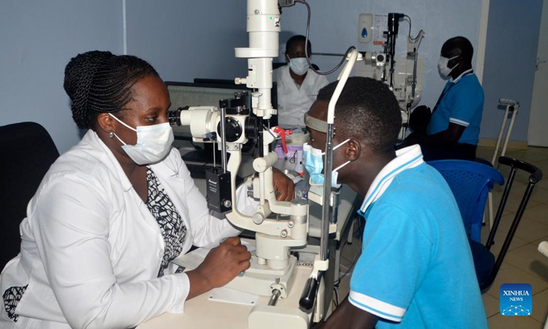 An ophthalmologist checks the eyes of a man during a free eye screening medical camp at Mengo Hospital, Kampala, Uganda, Oct. 15, 2021. To mark the World Sight Day that falls on Oct. 14 this year, over 300 people with diabetes received free eye screening treatment during a two-day medical camp event in Kampala.(Photo: Xinhua)