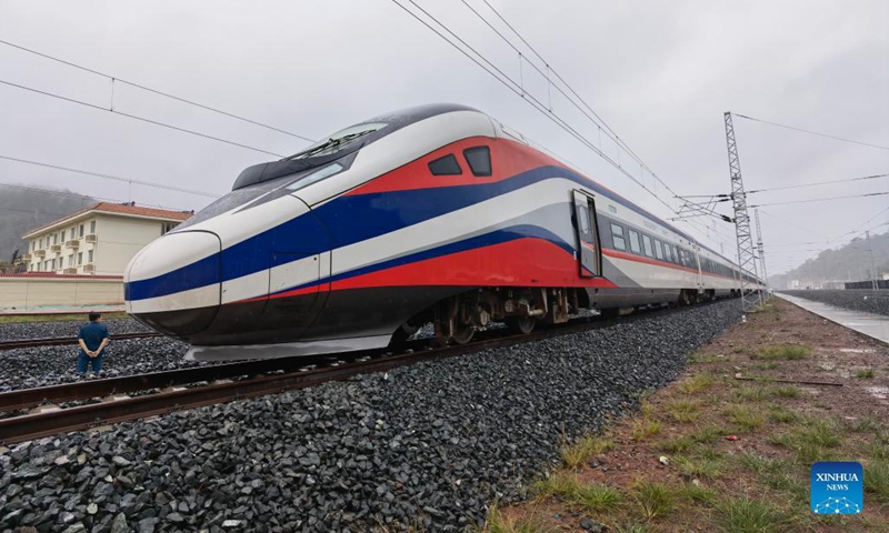 The Lane Xang EMU train arrives at the northern Laos' border town of Boten, after passing by the China-Laos borderline, Oct. 15, 2021. The streamlined China-standard bullet train, or electric multiple unit (EMU) train, for the China-Laos railway arrived at the newly built China-Laos Railway Vientiane Station on Saturday.(Photo: Xinhua)