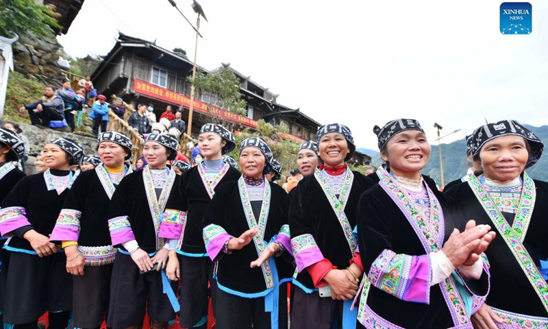 Elder people watch performance during an event celebrating the harvest season in Rongshui Miao Autonomous County, south China's Guangxi Zhuang Autonomous Region, Oct. 15, 2021.(Photo: Xinhua)