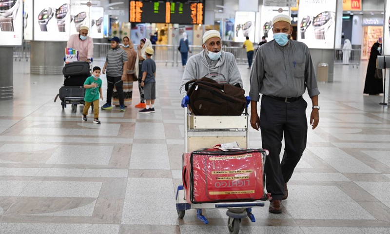 Passengers walk inside the arrival hall of Kuwait International Airport in Farwaniya Governorate, Kuwait, Oct. 24, 2021.(Photo: Xinhua)