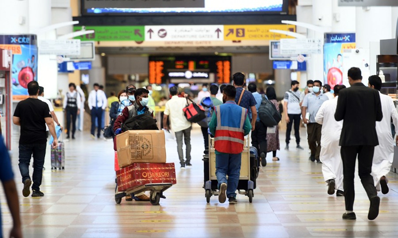 Passengers walk inside the departure hall of Kuwait International Airport in Farwaniya Governorate, Kuwait, Oct. 24, 2021. (Photo: Xinhua)
