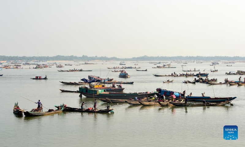 Workers excavate quarry sand, stones and other materials on the Jadukata river in Sunamganj, Bangladesh, Oct. 24, 2021. (Photo: Xinhua)