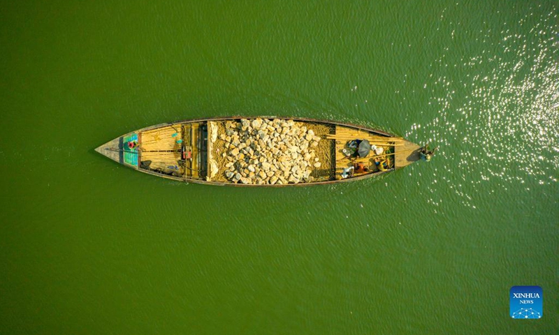 Aerial photo taken on Oct. 24, 2021 shows a boat loaded with stones on the Jadukata river in Sunamganj, Bangladesh. (Photo: Xinhua)